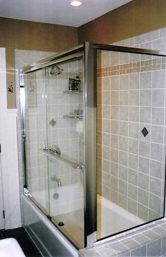 Bypass tub enclosure with return panel